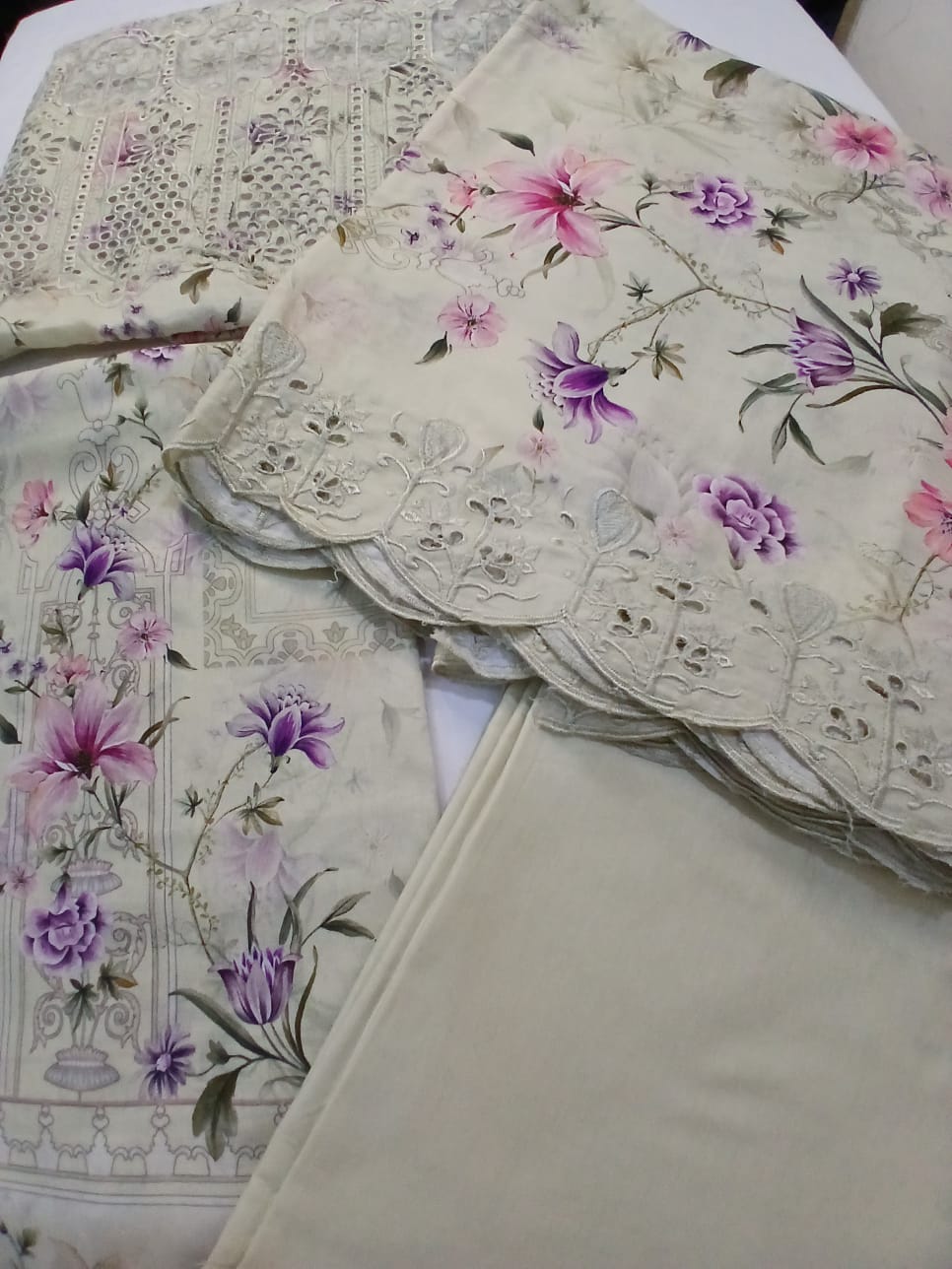 Off-white and cream lawn suit featuring full front embroidery with pink and purple floral digital print, summer 2026 collection by Aladeen Fabrics