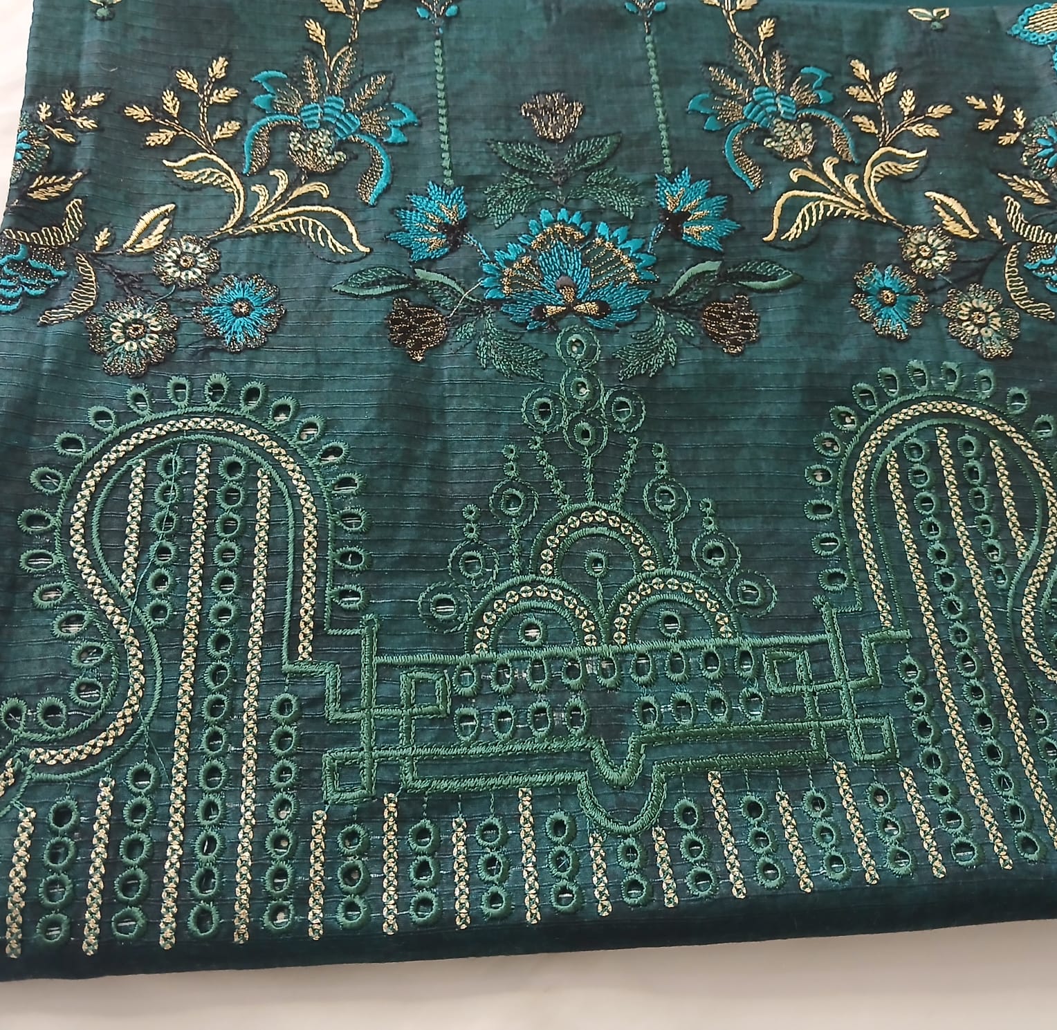Closeup of embroidery and sequence work on bottle green lawn shirt