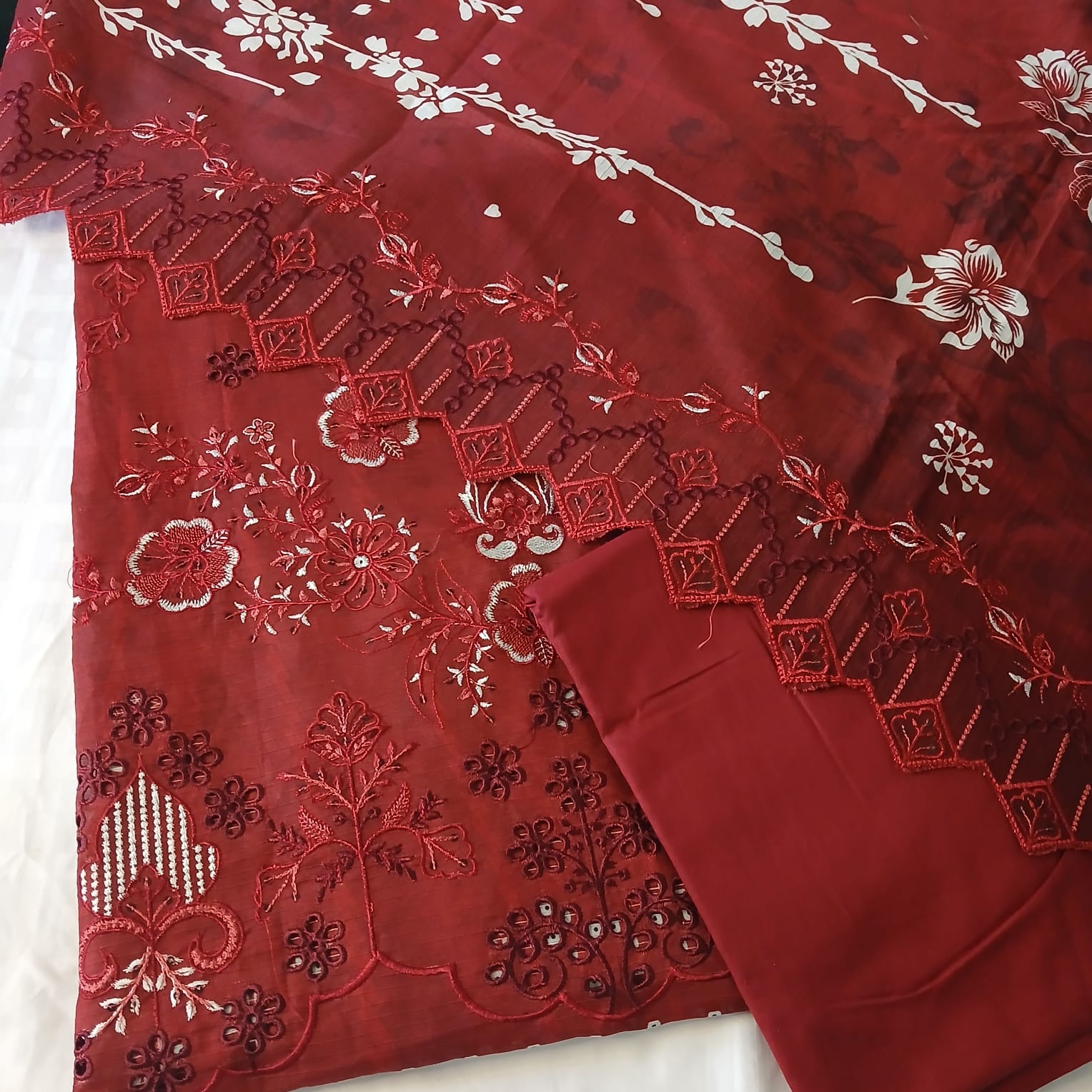 Closeup of heavy embroidery on red lawn shirt