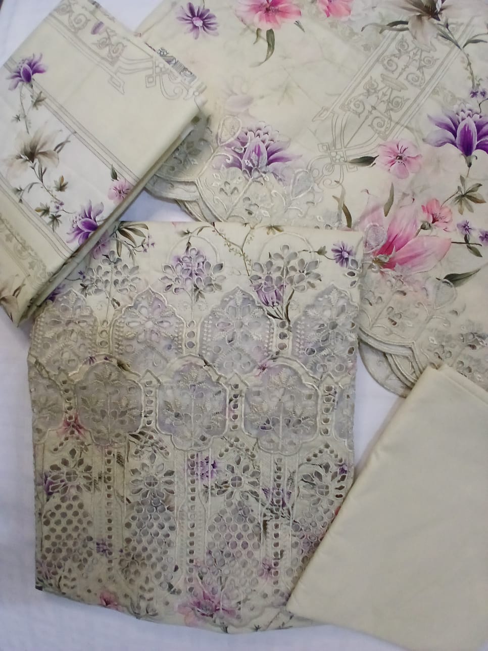 Complete three-piece lawn suit in off-white cream base with embroidered shirt, printed dupatta, and matching trouser for summer wear