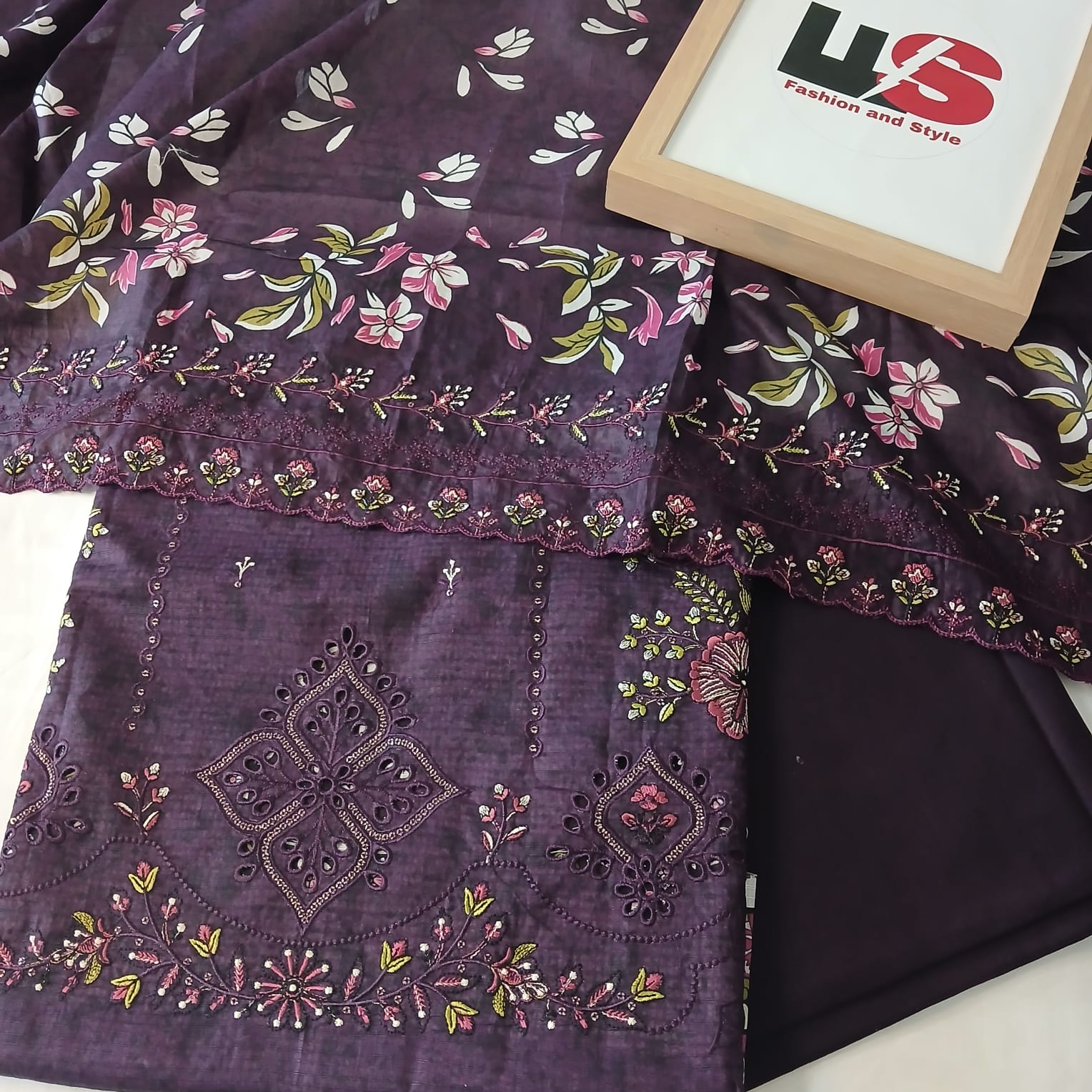 closeup of heavy embroidery on purple doria lawn shirt fabric